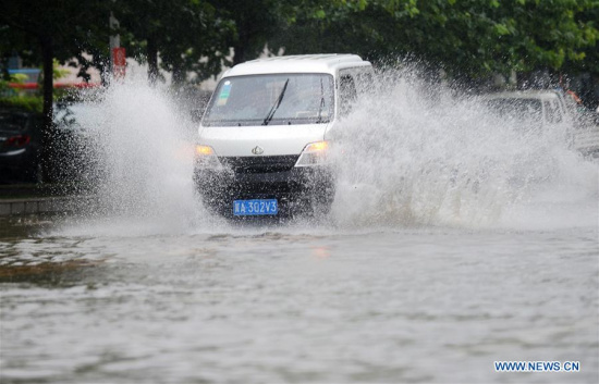 A car drives on a waterlogged road in Shijiazhuang, capital city of north China's Hebei Province, July 20, 2016. (Xinhua/Wang Xiao) 