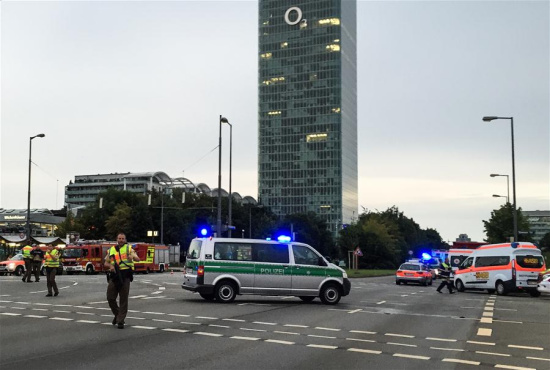 Photo taken by a mobile device shows police standing guard near the site of the shootout in Munich, Germany, on July 22, 2016. At least six people were killed in a shootout in the German city of Munich on Friday evening, German local media Focus Online reported. (Xinhua/Zhu Sheng)