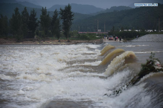 A swollen river is seen at Dayangshugou Village, Huludao City, northeast China's Liaoning Province, July 21, 2016. (Xinhua/Pan Yulong)