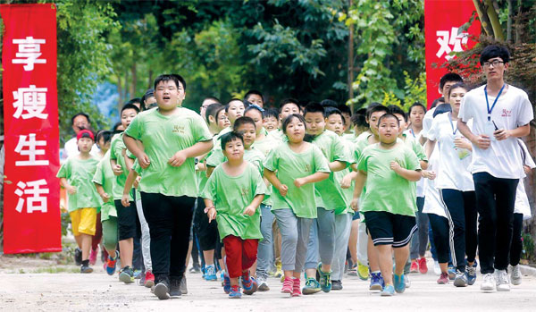 Children exercise at a summer camp for overweight minors in Qingdao, Shandong province, in July. (Photos by He Yi / For China Daily)