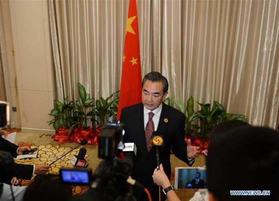 Chinese Foreign Minister Wang Yi(C) speaks to the press after the meetings in Vientiane, capital of Laos, on July 26, 2016. (Xinhua/Liu Ailun)