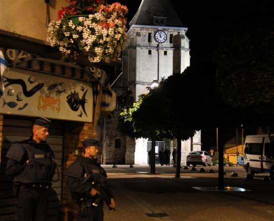 French police stand guard near the church which was attacked in Saint-Etienne-du-Rouvray, Seine-Maritime department, France, July 26, 2016. (Xinhua/Zhang Xuefei)