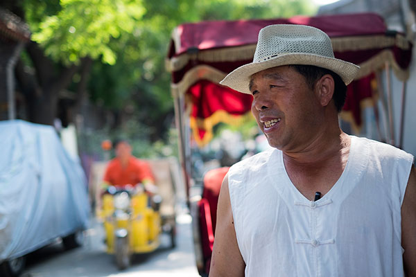 As a rickshaw driver in the hutong, Xin Yingwu witnessed the rise of modern commercialization first-hand.(Photo by Kyle Hodges/chinadaily.com.cn)