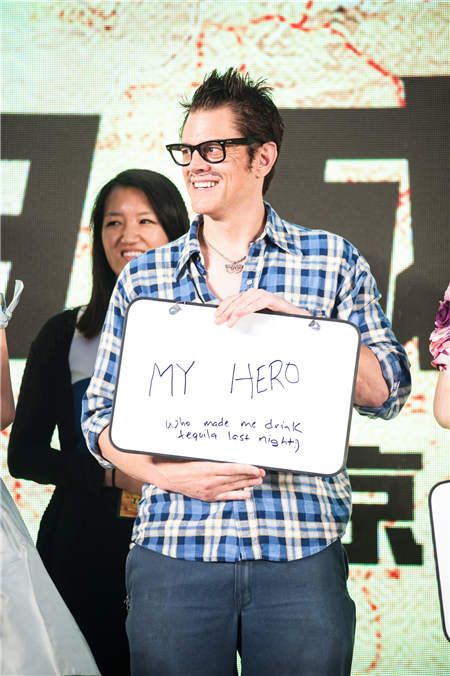 Johnny Knoxville shows a board at the film's news release in Beijing. He is known for the MTV reality stunt show Jackass.