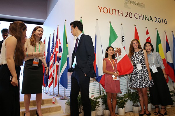 Representatives talk on the sidelines of Y20 China 2016 in Shanghai on Wednesday. The event for young adults is affiliated with the G20 Leaders Summit, which will take place in September. (Photo/China Daily)