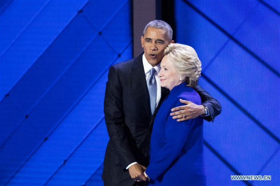 U.S. President Barack Obama (L) hugs U.S. Democratic Presidential Candidate Hillary Clinton on the third day of the 2016 U.S. Democratic National Convention, at Wells Fargo Center in Philadelphia, Pennsylvania, the United States, on July 27, 2016. (Photo: Xinhua/Li Muzi)