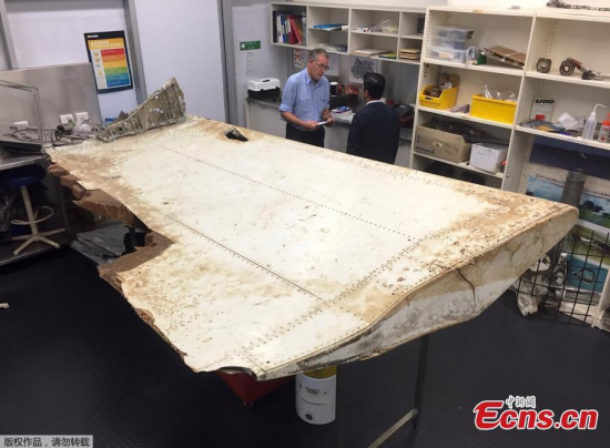 Australian and Malaysian officials examine aircraft debris at the Australian Transport Safety Bureau headquarters in Canberra, Australia, July 20, 2016 after it was found on Pemba Island, located near Tanzania, in late June and was transported to Australia for examination. (Photo/Agencies)