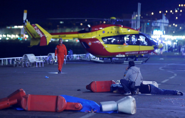An injured individual is seen on the ground after at least 30 people were killed in Nice, France, when a truck ran into a crowd celebrating the Bastille Day national holiday July 14, 2016.