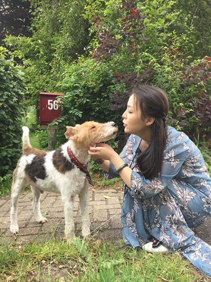 Yu Zhu with her pet dog. CHINA DAILY