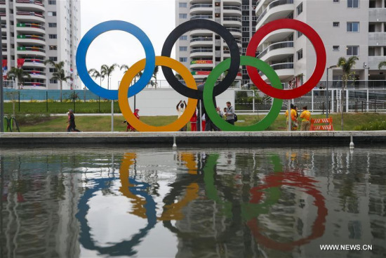People take photos in front of a sculpture of Olympic at the Olympic village in Rio de Janeiro, Brazil, on Aug. 2, 2016. (Photo/Xinhua)