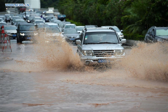 Cars go through a waterlogged road in Nanning, capital of south China's Guangxi Zhuang Autonomous Region, Aug. 3, 2016. Typhoon Nida resulted in torrential rain here on Wednesday. (Xinhua/Zhou Hua) 