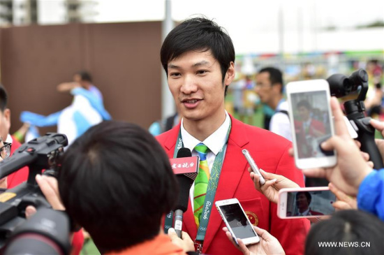 Lei Sheng of the Chinese delegation receives an interview prior to the flag-raising ceremony at the Olympic Village in Rio de Janeiro, Brazil, on Aug. 3, 2016. (Xinhua/Yue Yuewei)
