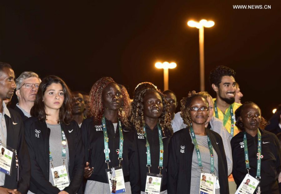 Members of the delegation of Refugee Olympics Team to the Rio 2016 Olympic Games attend the flag-raising ceremony at the Olympic Village in Rio de Janeiro, Brazil, on Aug. 3, 2016. (Xinhua/Yue Yuewei)