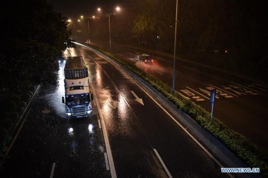 A truck runs amid heavy rain on a road in Shenzhen, south China's Guangdong Province, Aug. 2, 2016. (Xinhua/Mao Siqian)
