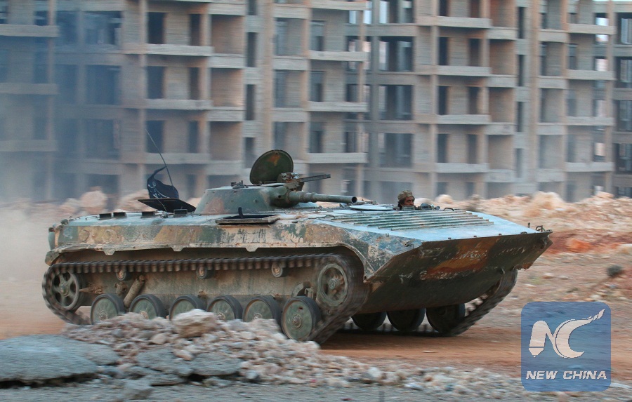 A fighter of the Syrian Islamist rebel group Jabhat Fateh al-Sham, the former al Qaeda-affiliated Nusra Front, rides in an armoured vehicle in the 1070 Apartment Project area in southwesternAleppo, Syria August 5, 2016. (Xinhua/Reuters Photo)