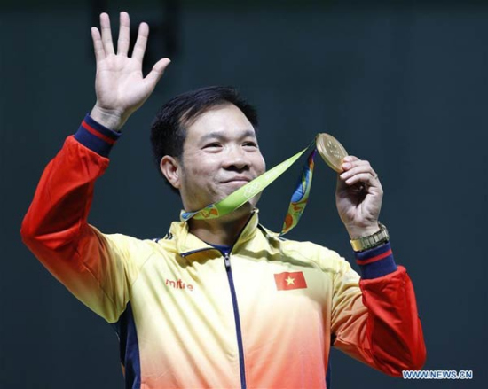 Hoang Xuan Vinh of Vietnam reacts during the awarding ceremony of the Men's 10m Air Pistol Finals of the 2016 Rio Olympic Games at the Olympic Shooting Centre in Rio de Janeiro, Brazil, on Aug 6, 2016. (Photo/Xinhua)