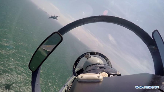 A Chinese fighter plane partols over the South China Sea. Chinese Air Force aircraft, including H-6K bombers and Su-30 fighters, have completed a patrol of airspace above the Nansha and Huangyan islands in the South China Sea, said a spokesperson Saturday.  (Xinhua/Fan Yishu)