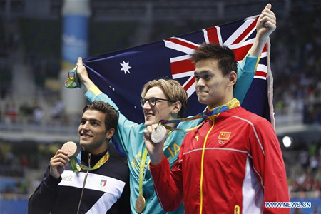 Gold medalist Australia's Mack Horton (C), silver medalist China's Sun Yang (R) and bronze medalist Italy's Gabriele Detti pose for photos after the awarding ceremony of men's 400m freestyle swimming final at the 2016 Rio Olympic Games in Rio de Janeiro, Brazil, on Aug. 6, 2016.Xinhua/Fei Maohua