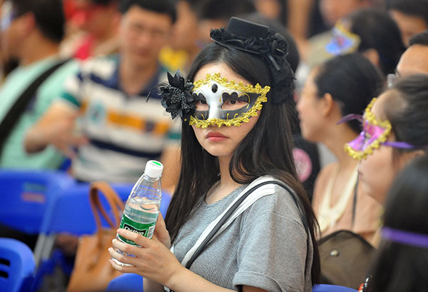 A masked girl participates in a joint dating party in Wuhan, Hubei province, on Saturday, celebrating the upcoming Qixi Festival. MIAO JIAN/CHINA DAILY