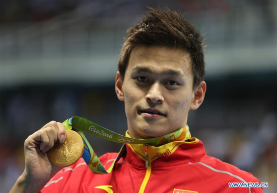 Sun Yang of China shows his medal during the awarding ceremony of men's 200m freestyle swimming final at the 2016 Rio Olympic Games in Rio de Janeiro, Brazil, on Aug. 8, 2016. Sun Yang won the gold medal with 1 minute 44.65 seconds.Xinhua/Fei Maohua