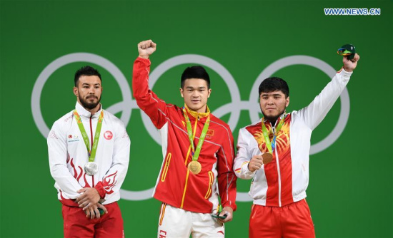 Shi Zhiyong of China (C), Daniyar Ismayilov of Turkey (L) and Izzat Artykov of Kyrgyzstan celebrate at the awarding ceremony of the men's 69KG weightlifting group A final at the 2016 Rio Olympic Games in Rio de Janeiro, Brazil, on Aug. 9, 2016. Shi Zhiyong won the gold medal with 352KG. (Xinhua/Cheng Min)