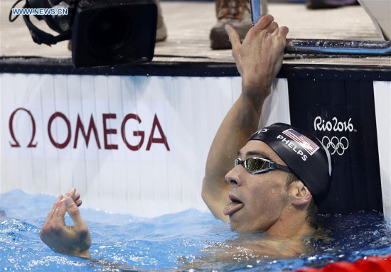 Michael Phelps of the United States of America reacts after the mens 200m butterfly final of swimming at the 2016 Rio Olympic Games in Rio de Janeiro, Brazil, on Aug. 9, 2016. Michael Phelps won the gold medal with 1 minute 53.36 seconds. (Xinhua/Fei Maohua) 