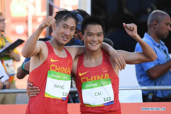 China's Wang Zhen (L) and his compatriot Cai Zelin celebrate after the men's 20km race walk of Athletics at the 2016 Rio Olympic Games in Rio de Janeiro, Brazil, on Aug. 12, 2016. Wang Zhen claimed the title with a time of 1:19:14. (Xinhua/Lui Siu Wai)