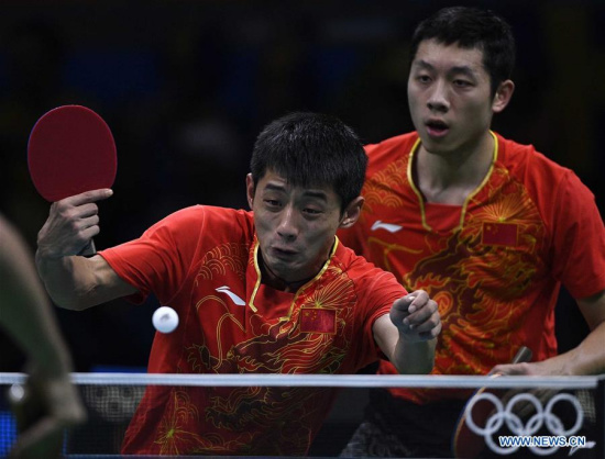 China's Zhang Jike (L) and Xu Xin compete during men's team quarterfinal of Table Tennis against Britain at the 2016 Rio Olympic Games in Rio de Janeiro, Brazil, on Aug. 14, 2016. China won 3-0. (Xinhua/Wang Peng)
