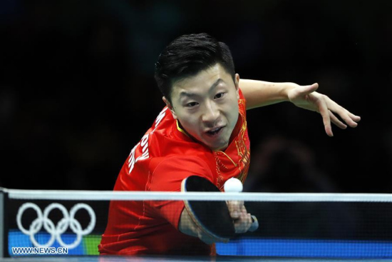 China's Ma Long competes during the men's singles table tennis final against Zhang Jike of China at the 2016 Rio Olympic Games in Rio de Janeiro, Brazil, on Aug. 11, 2016. Ma Long won the gold medal. (Xinhua/Shen Bohan)
