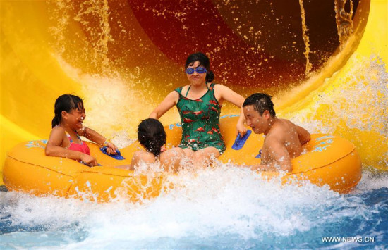 Local residents have a good time in an aqua park amid hot weather in Luzhou, southwest China's Sichuan Province, Aug. 13, 2016. (Xinhua/Yang Tao)