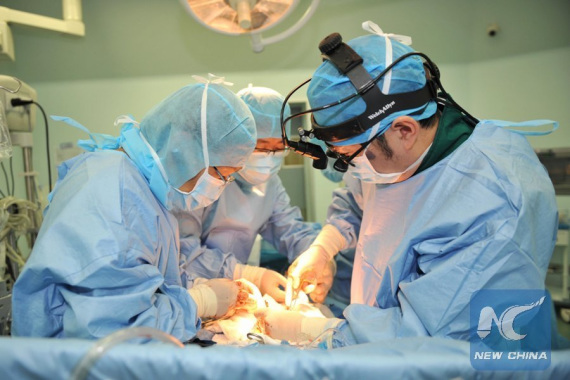 Doctors conduct a heart surgery for a child at Teda International Cardiovascular Hospital in north China's Tianjin Municipality, May 25, 2016. (Photo: Xinhua/Lian Yi)