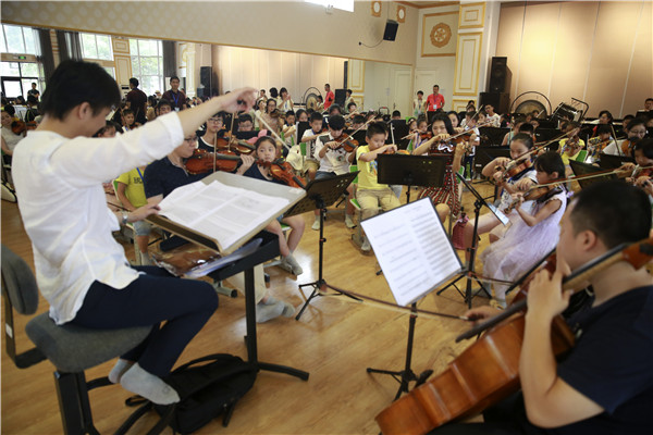 Children practice different musical instruments during a 10-day music camp in Beijing. The non-professionals will give a performance at the Beijing Concert Hall on Monday. FENG YONGBIN/CHINA DAILY