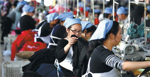 Women employees work at a garment factory in Huaibei, Anhui province.  (Xie Zhengyi/for China Daily)