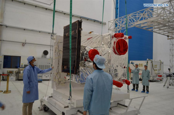 File photo taken on July 27, 2016 shows technical staff install solar wing for the experimental quantum communication satellite at the Jiuquan Satellite Launch Center in Jiuquan, northwest China's Gansu Province. (Photo/Xinhua)