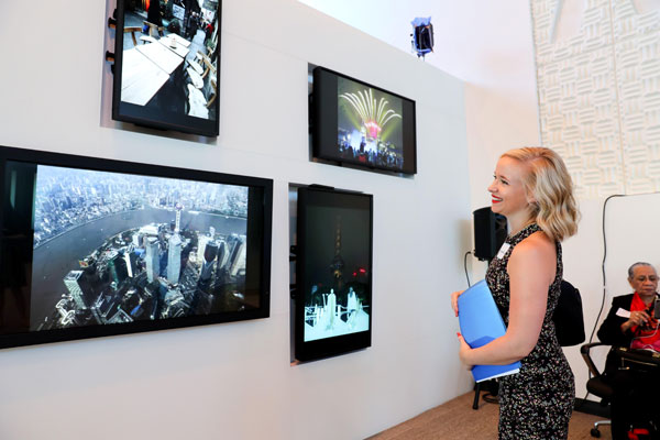 A visitor enjoys the images of Shanghai during a campaign promoting Shanghai's tourism launched in New York on Aug 23, 2016. (Photo/Xinhua)