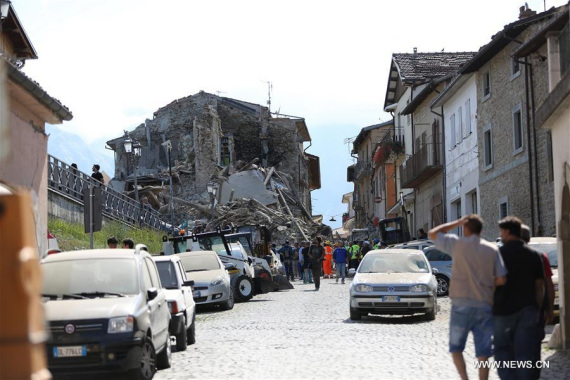 Photo taken on Aug. 24, 2016 shows damaged houses after an earthquake in Amatrice, central Italy. The 6.0 magnitude earthquake hit the city of Rieti at 3:32 a.m. Wednesday (0132 GMT), with a shallow depth of 4.2 km, according to the National Institute of Volcanology and Seismology. (Photo Xinhua/Jin Yu)