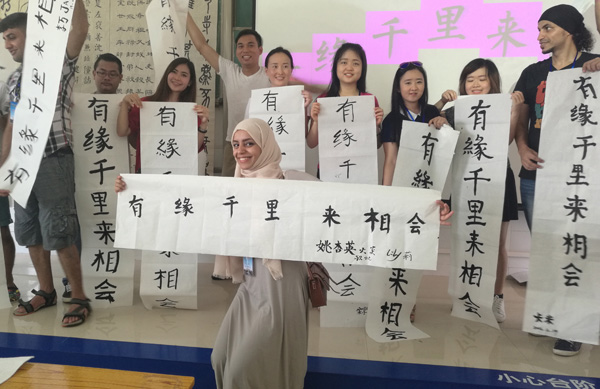 Students from Southeast Asian countries show their calligraphy works at Qinzhou University in the Guangxi Zhuang autonomous region in June. (Photo by HUO YAN/CHINA DAILY)