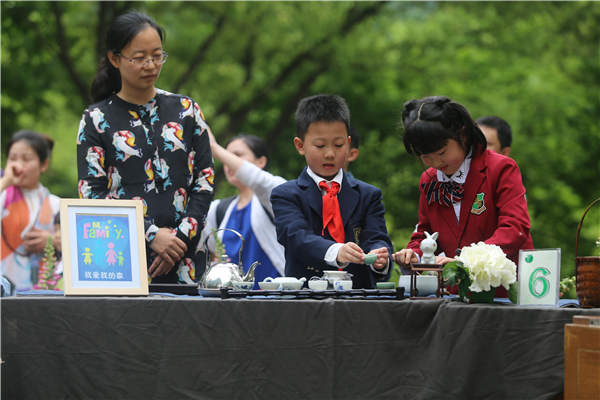 Children learn to make tea in a traditional way.