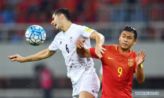 China's Zhang Yuning (R) vies with Iran's Saeid Ezatolahi during the Russia 2018 World Cup Asian Qualifier match between China and Iran in Shenyang, capital of northeast China's Liaoning Province, on Sept. 6, 2016. (Photo: Xinhua/Tao Xiyi)