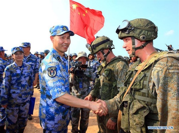 Wang Hai, Chinese chief director of the exercise and deputy commander of the Chinese Navy, shakes hands with Russian marines during a joint naval drill in Zhanjiang, south China's Guangdong Province, Sept. 14, 2016.  (Photo: Xinhua/Zha Chunming)