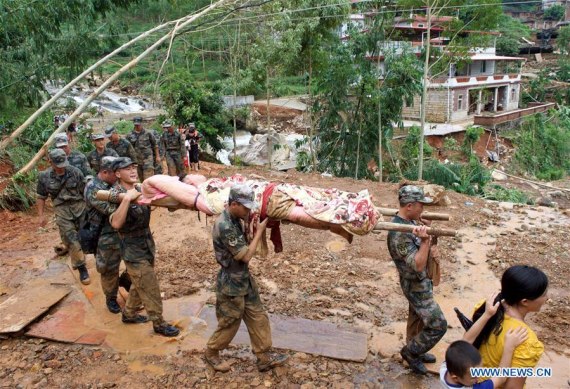 Rescuers relocate an injured man in Nan'an, southeast China's Fujian Province, Sept. 16, 2016. Disaster relief and reconstruction were launched after Typhoon Meranti swept away and left severe damages. (Photo: Xinhua/Jiang Kehong) 