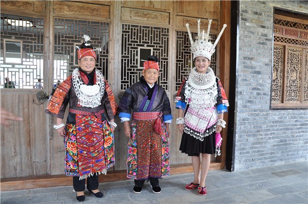 Miao women display their traditional costumes and silver ornaments in eastern Guizhou province. (LIU XIANGRUI/CHINA DAILY)