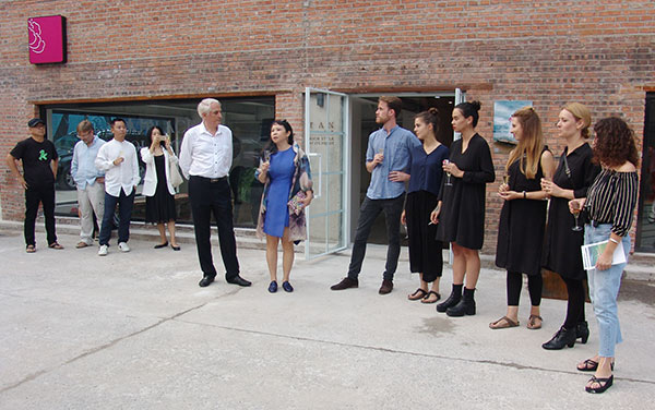 Curator Wang Tao (2nd, L) delivers a speech at the opening ceremony of the exhibition Voices at the TAN Gallery in 798 Art District, Beijing, Sept 24, 2016. (Photo provided to chinadaily.com.cn)