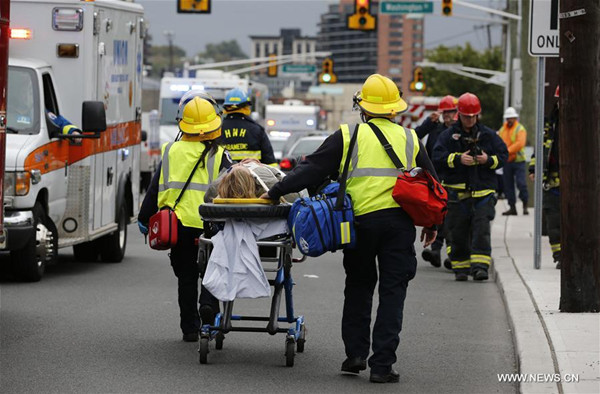 A victim is wheeled on a stretcher out of the Hoboken station following a train crash in New Jersey, the United States on Sept. 29, 2016. One person was confirmed killed and 108 others injured after a transit train crashed into New Jersey's Hoboken station during the morning rush hour Thursday. (Xinhua/Gary Hershorn)
