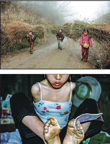 Top: Xiang Liping (right) and her two younger brothers carry bundles of straw home in November, 2002. Above: Without arms,Xiang uses her feet to do needlework.