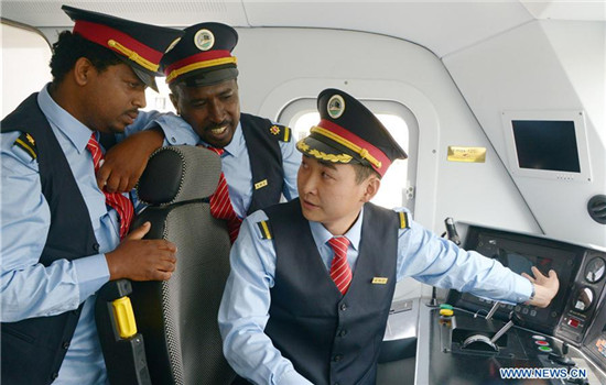 Chinese locomotive driver Liu Ji (R) trains his Ethiopian counterparts at a railway station in suburban Addis Ababa, Ethiopia, Oct. 1, 2016. A Chinese-built railway linking the Ethiopian capital and the port of Djibouti is expected to help the landlocked African country improve access to the sea and speed up a burgeoning industrialization process.(Xinhua/Sun Ruibo)