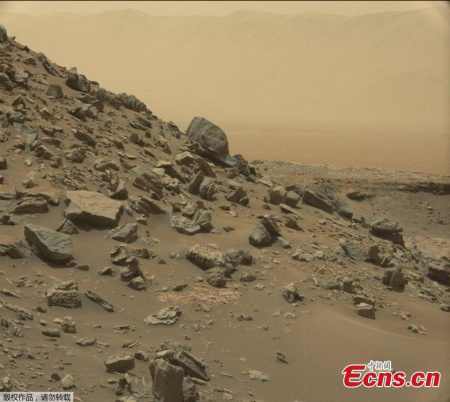 This image take by NASA's Curiosity Mars Rover shows a dramatic hillside outcrop with sandstone layers.   (Photo/NASA)