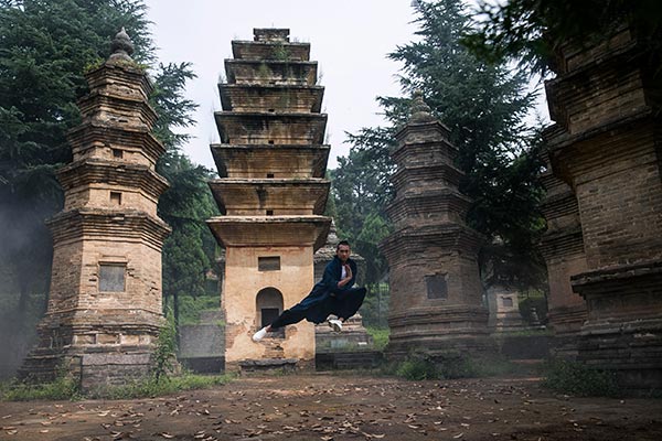 Zhao Wenzhuo, a Chinese film star, performs kung fu at the Pagoda Forest of Shaolin Temple in Central China. (Photo by Chen Wei/China Daily)