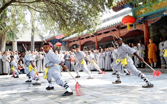 African apprentices perform Kungfu at the Shaolin Temple on the Songshan Mountain in Dengfeng City, Central China's Henan province, Sept 23, 2016. A total of twenty apprentices from Africa graduated here on Friday after three-month training programs on Kungfu and Shaolin culture. (Photo/Xinhua)