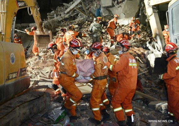 Rescuers carry the body of a victim at the accident site in Lucheng industrial district in Wenzhou City, east China's Zhejiang Province, Oct. 10, 2016.  (Photo/Xinhua)